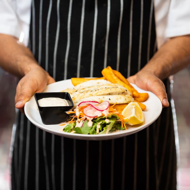 Photo of chef with food in hand